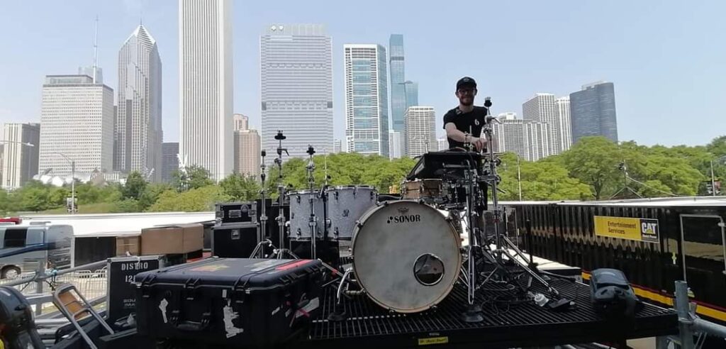 picture of a drum tech setting up a kit